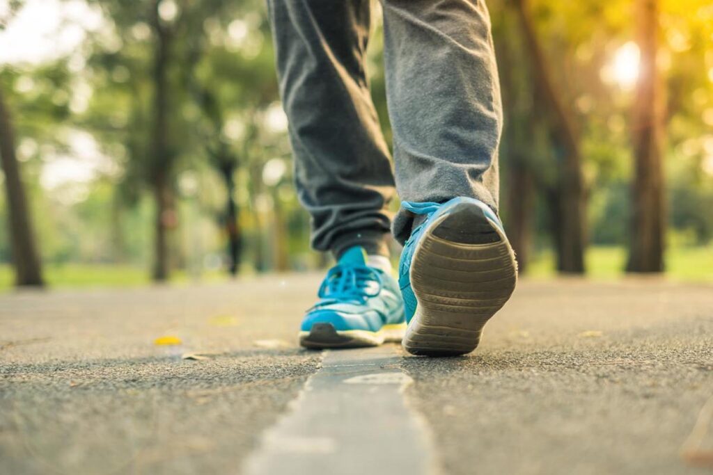 What is Walking and why is it good for your fitness - Man running with shoe half picture