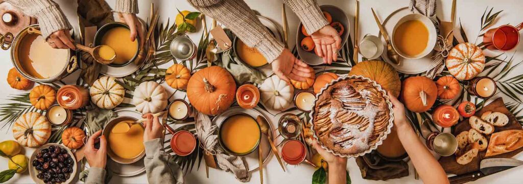 common mistakes after meals - People eating over fall festive table set, top view